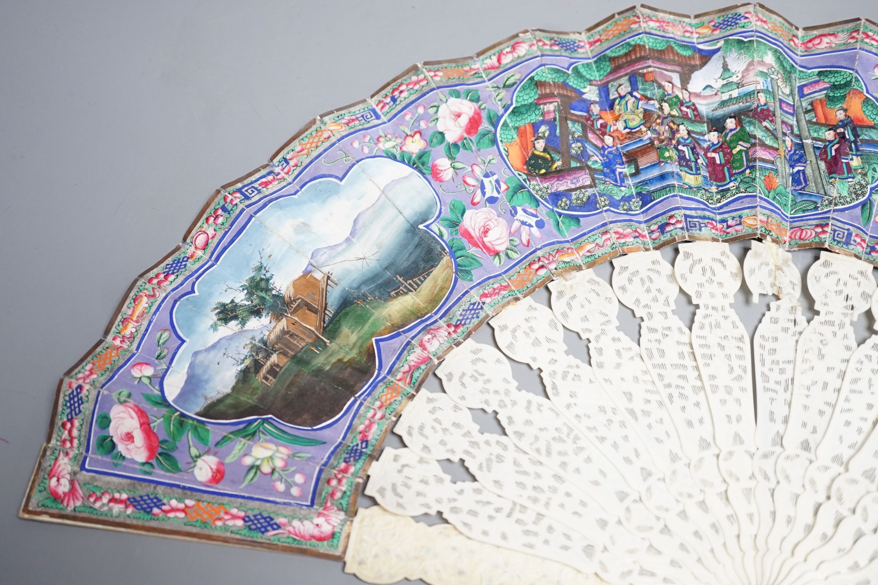 A 19th century Chinese export pierced ivory and painted paper leaf fan, in box. Fan 28cm long